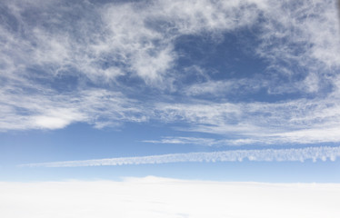 the sky when i am looking through window aircraft during flight in wing with a blue sky.