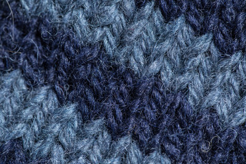 A beautiful closeup of a hand knitted warm and soft wool pattern. Soft socks or scarf of natural wool. Colorful pattern.