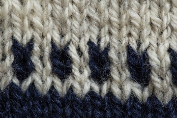 A beautiful closeup of a hand knitted warm and soft wool pattern. Soft socks or scarf of natural wool. Colorful pattern.