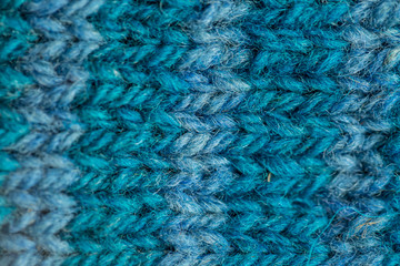 A beautiful closeup of a hand knitted warm and soft wool pattern. Soft socks or scarf of natural wool. Colorful pattern.