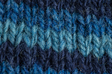 A beautiful closeup of a hand knitted warm and soft wool pattern. Soft socks or scarf of natural wool. Colorful pattern.