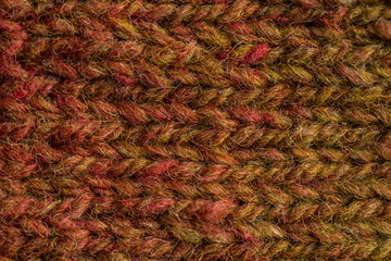 A beautiful closeup of a hand knitted warm and soft wool pattern. Soft socks or scarf of natural wool. Colorful pattern.