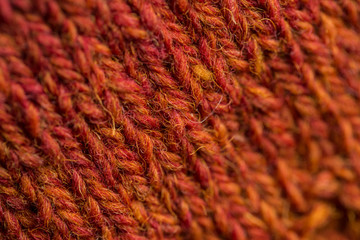 A beautiful closeup of a hand knitted warm and soft wool pattern. Soft socks or scarf of natural wool. Colorful pattern.