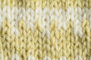 A beautiful closeup of a hand knitted warm and soft wool pattern. Soft socks or scarf of natural wool. Colorful pattern.