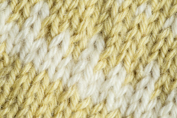 A beautiful closeup of a hand knitted warm and soft wool pattern. Soft socks or scarf of natural wool. Colorful pattern.