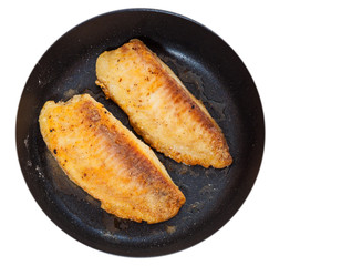 Fried fish fillet in a frying pan. top view. isolated on white