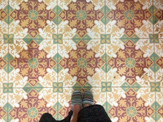 Feet over vintage tiled floor