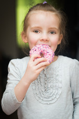 The girl eats the donut