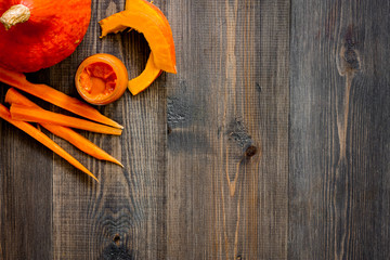 Baby food. Pumpkin puree on dark wooden table background top view copyspace