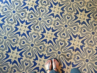 Feet over vintage tiled floor