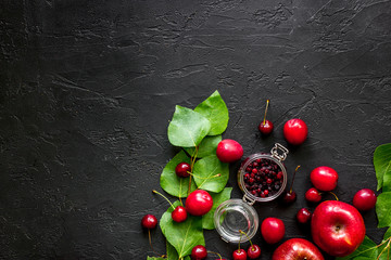 Cranberry, cranberry, pulm and cherry for summer fruit drink black stone table top view copyspace