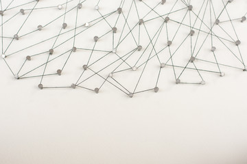 Linking entities. Network, networking, social media, internet communication abstract. A small network connected to a larger network. in paper linked together by cotton with a black tint