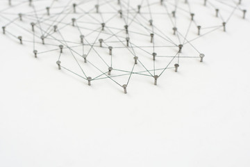 Linking entities. Network, networking, social media, internet communication abstract. A small network connected to a larger network. in paper linked together by cotton with a black tint