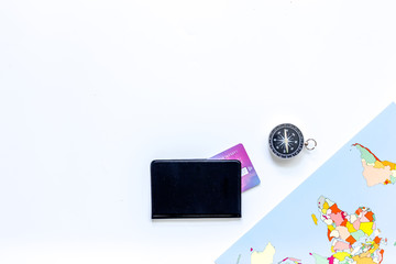 Planning trip. World map, compass and bank card on white background top view copyspace