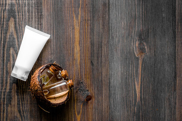 Skin care. Coconut cream and lotion on wooden table background top view copyspace