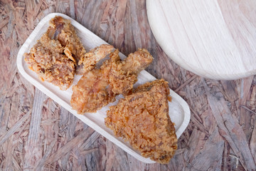 fried chicken meal on wood dish, top view