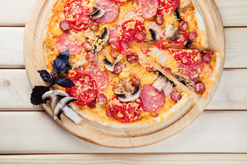 Mushroom pizza on the wooden background