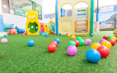 colorful plastic ball on green turf at school playground
