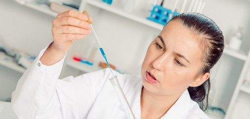 Fototapeta premium Young female scientist in lab , doing experiments in lab.