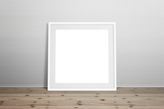 White picture frame mockup. Isolated frame for art, design presentation. Frame leaning on white wall. Wooden floor.
