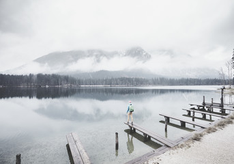 Tourist at winter mountain lake