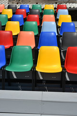 colorful plastic chairs  in rows 