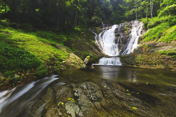 A couple enjoying their time at waterfall. A travel concept.