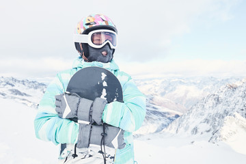 Fototapeta na wymiar Young woman with snowboard