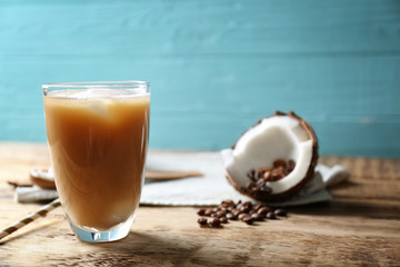 Glass of cold tasty coconut coffee on table