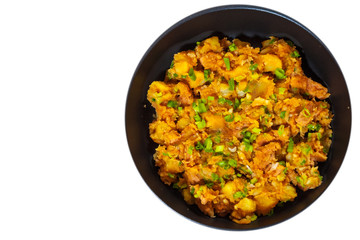 stewed meat with potatoes, onion in a frying pan. top view. isolated on white