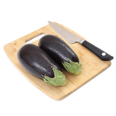 The eggplant on the cutting board in the kitchen on isolated white background