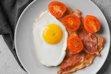 Tasty breakfast with fried egg on table