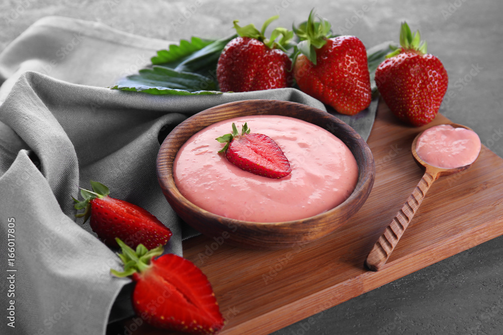 Poster composition with fresh homemade yogurt and strawberries on wooden board