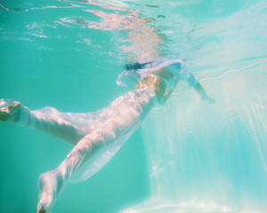 woman beautiful body swim underwater in white dress