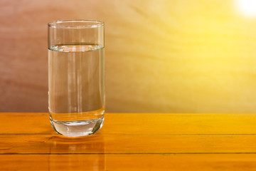 Drinking water in a glass on a wooden table
