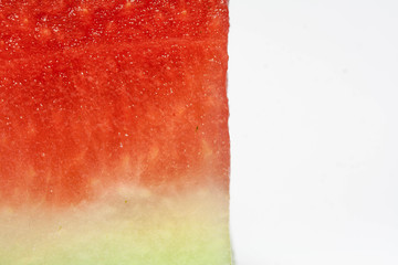 Pulp of watermelon with pitted peel on a light background