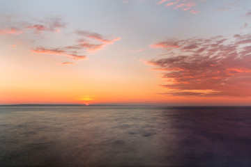 sunrise on the water / Early summer morning bright sky Beach
