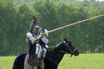 Medieval knight in armor on horseback