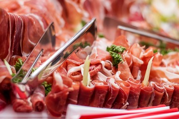 Catering food served decorated in plates with ham, cheese, pork and vegetables