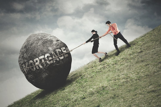 People pull stone with mortgage word - Powered by Adobe