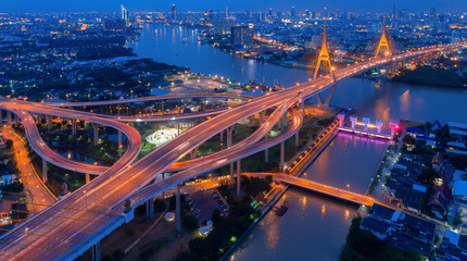 Top view over the highway,expressway and motorway at night, Aerial view interchange of a city, Shot from drone,Expressway is an important infrastructure in Thailand - obrazy, fototapety, plakaty