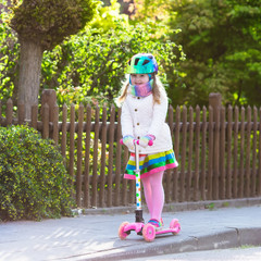 Child riding schooter on way to school