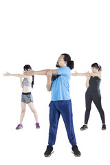 Obraz premium Young people doing stretching together