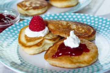 Pancakes  with fresh raspberries,berry jam and a little whipped cream