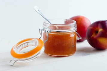 side view of nectarine/peach jam with a spoon in it