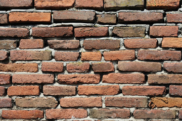 Weathered wall made of orange bricks