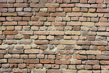 Weathered wall made of orange bricks