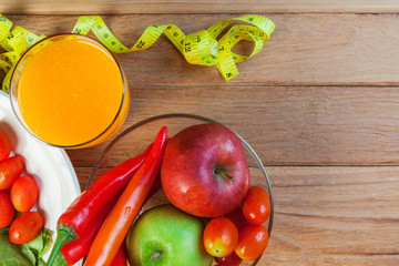 Healthy concept with mixed fruits and vegetables on wooden background