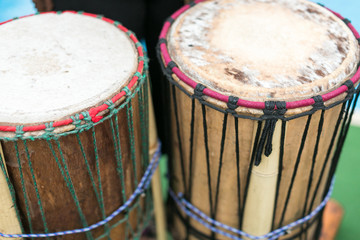 drum, percussion musical instruments and culture concept - closeup on traditional african djembe,...