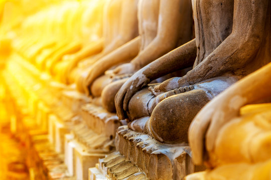Row of Budda statues in sunlight, maditation pose, Peace of mind background concept
